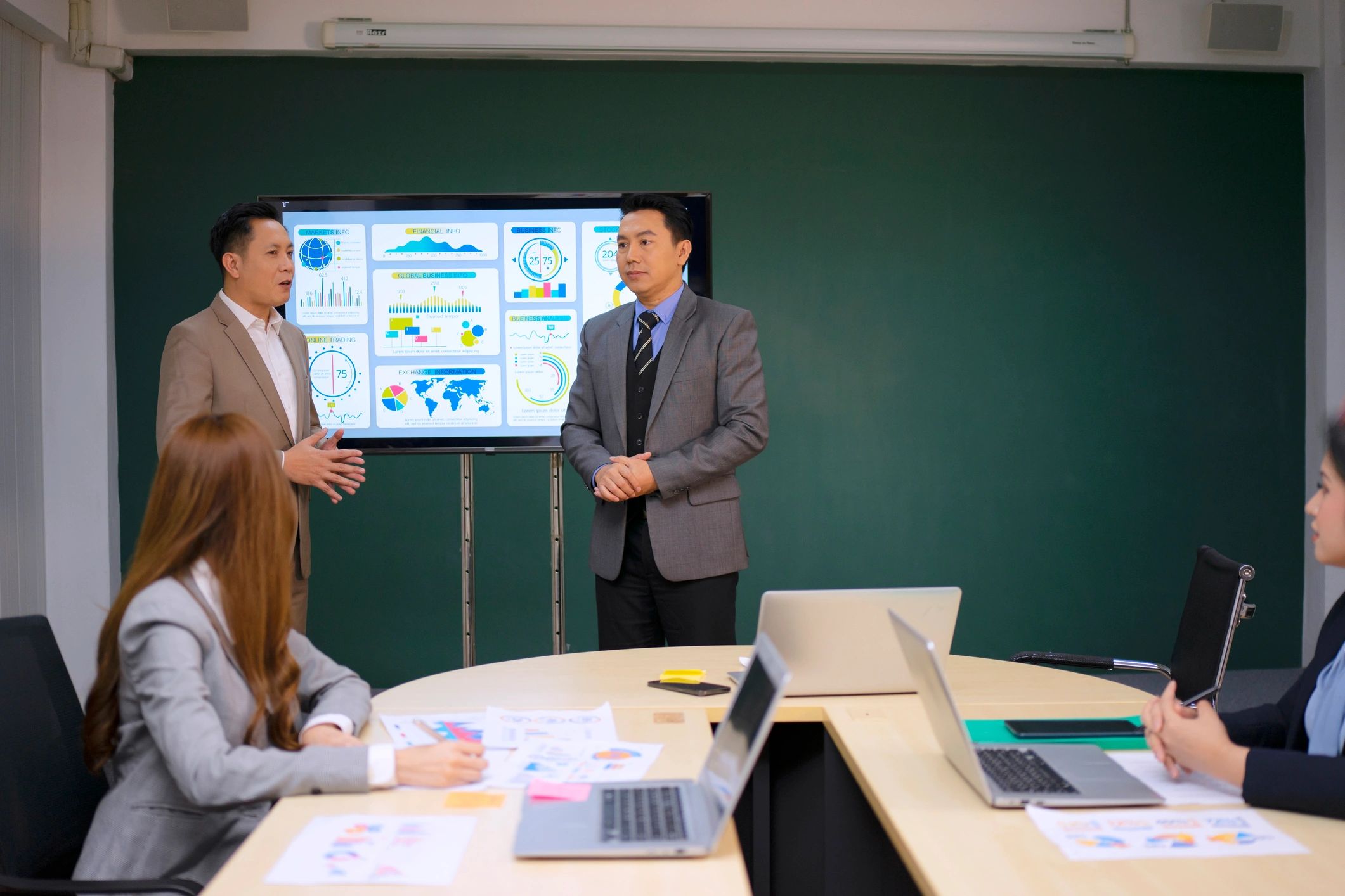 Professionals discussing charts and business trends in an office