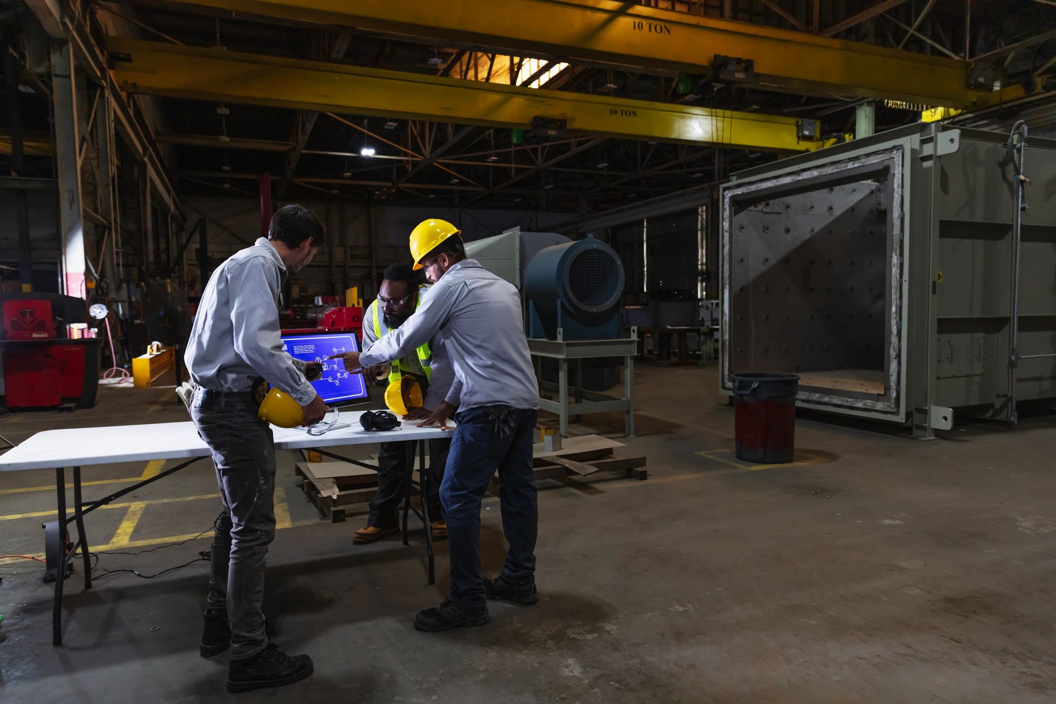 Factory workers reviewing digital production data